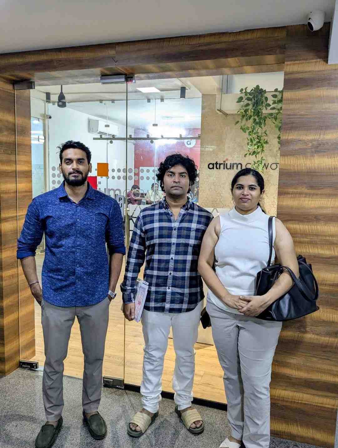 Three Atrium clients standing at the Atrium Coworks entrance